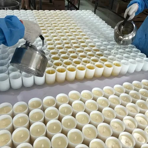 Wickbond team hand-pouring warm wax into candle vessels wearing gloves for hygiene